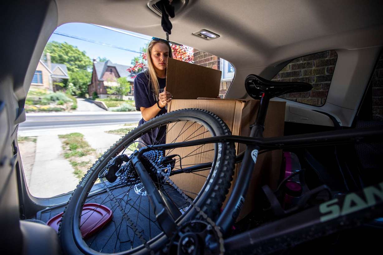 Sadie Texer removes items from her car at her new home in Salt Lake City on Saturday June 12, 2021.