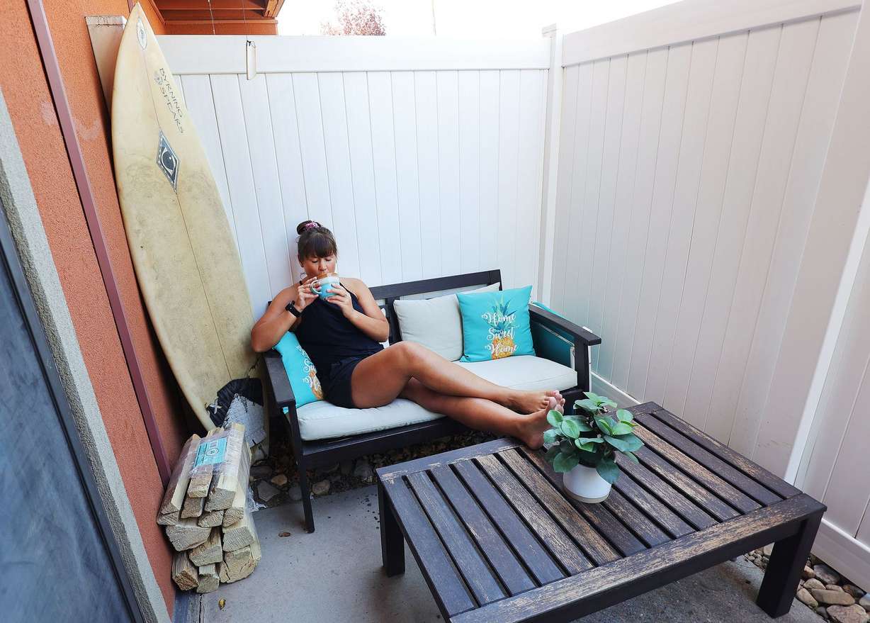 Kayla Smartz enjoys a beverage on the patio of her apartment in Salt Lake City on Friday, June 4, 2021.