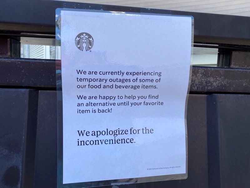 A note is seen attached to a Starbucks drive-through menu alerting customers that some items may be temporarily unavailable in Poughkeepsie, New York, on June 23, 2021.