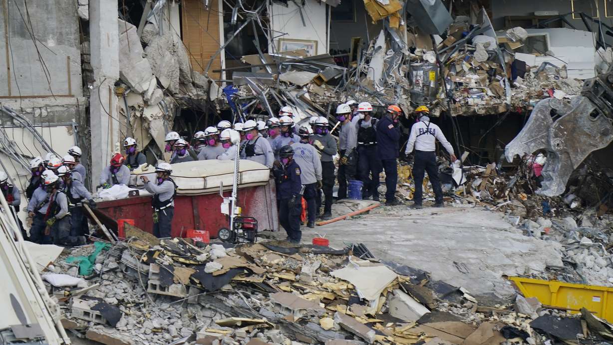 Workers search the rubble at the Champlain Towers South Condo, Monday, June 28, 2021, in Surfside, Fla. Many people were still unaccounted for after Thursday's fatal collapse.