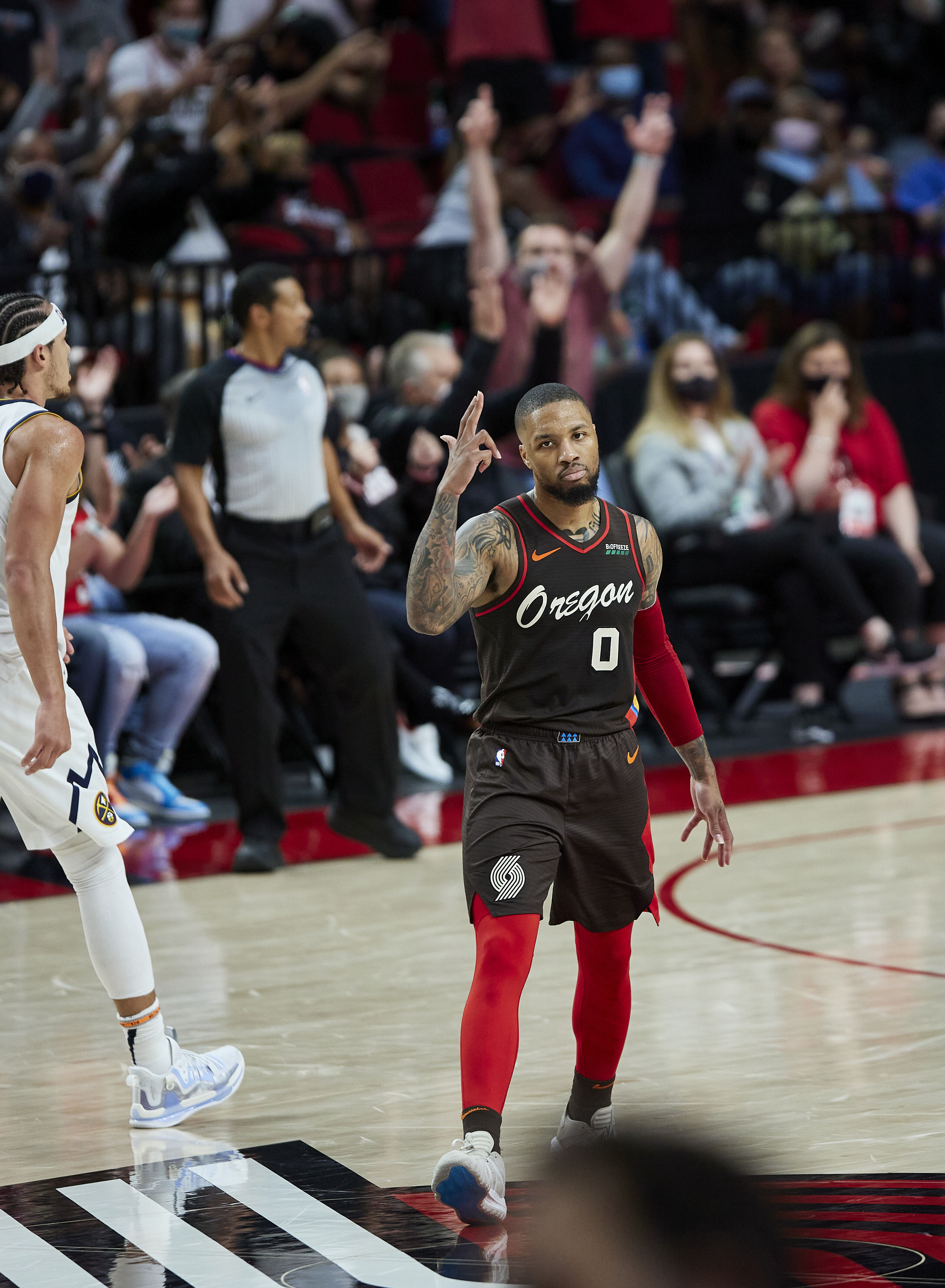 Portland Trail Blazers guard Damian Lillard reacts after making a 3-point basket against the Denver Nuggets during the first half of Game 6 of an NBA basketball first-round playoff series Thursday, June 3, 2021, in Portland, Ore.