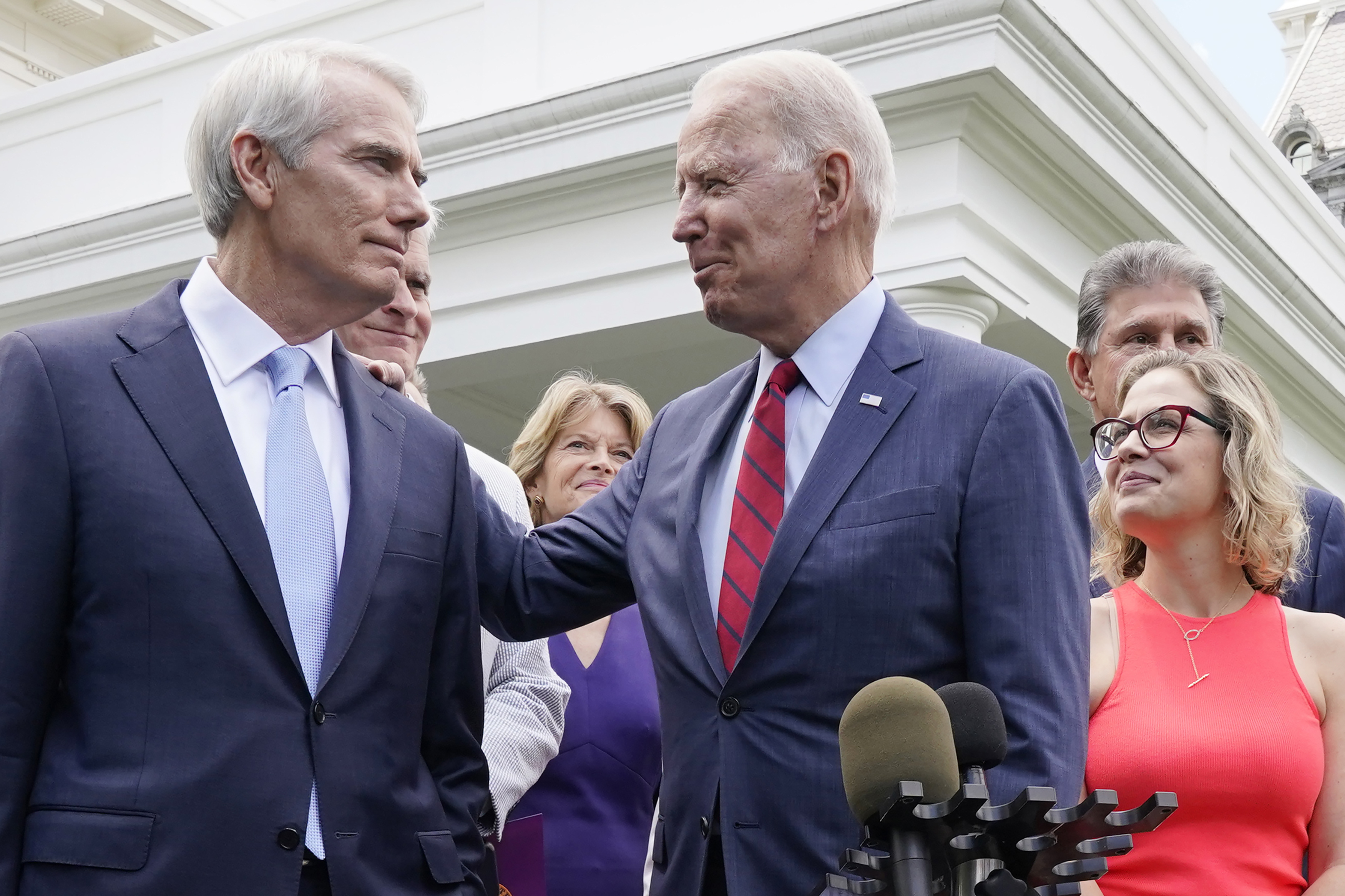 President Joe Biden speaks with Sen. Rob Portman, R-Ohio, and a bipartisan group of senators on Thursday, June 24, 2021, outside the White House. Biden will look to sell voters on the economic benefits of the $973 billion infrastructure package while in Wisconsin on Tuesday.