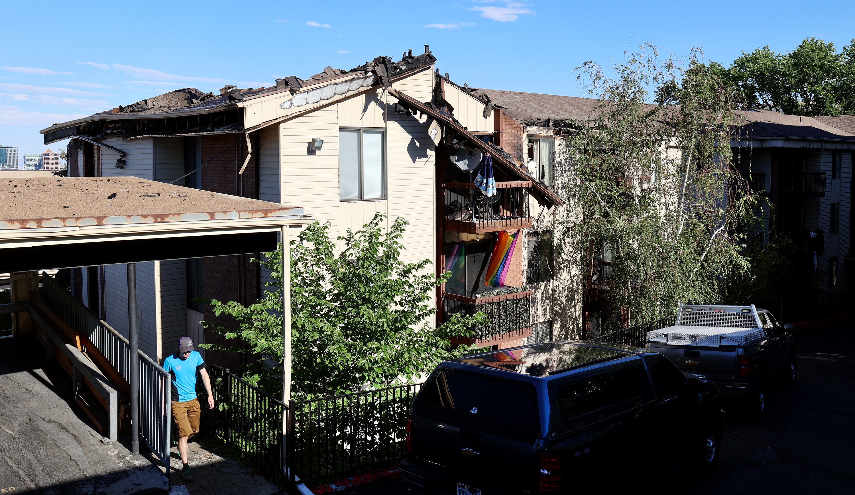 A man walks up the stairs at the Incline Terrace Condos at 1032 E. 400 South during an investigation of a fire in Salt Lake City on Monday, June 28, 2021. 