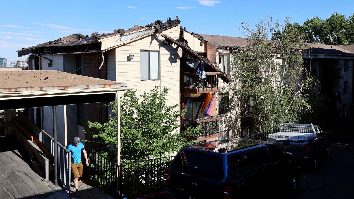 A man walks up the stairs at the Incline Terrace Condos at 1032 E. 400 South during an investigation of a fire in Salt Lake City on Monday, June 28, 2021.