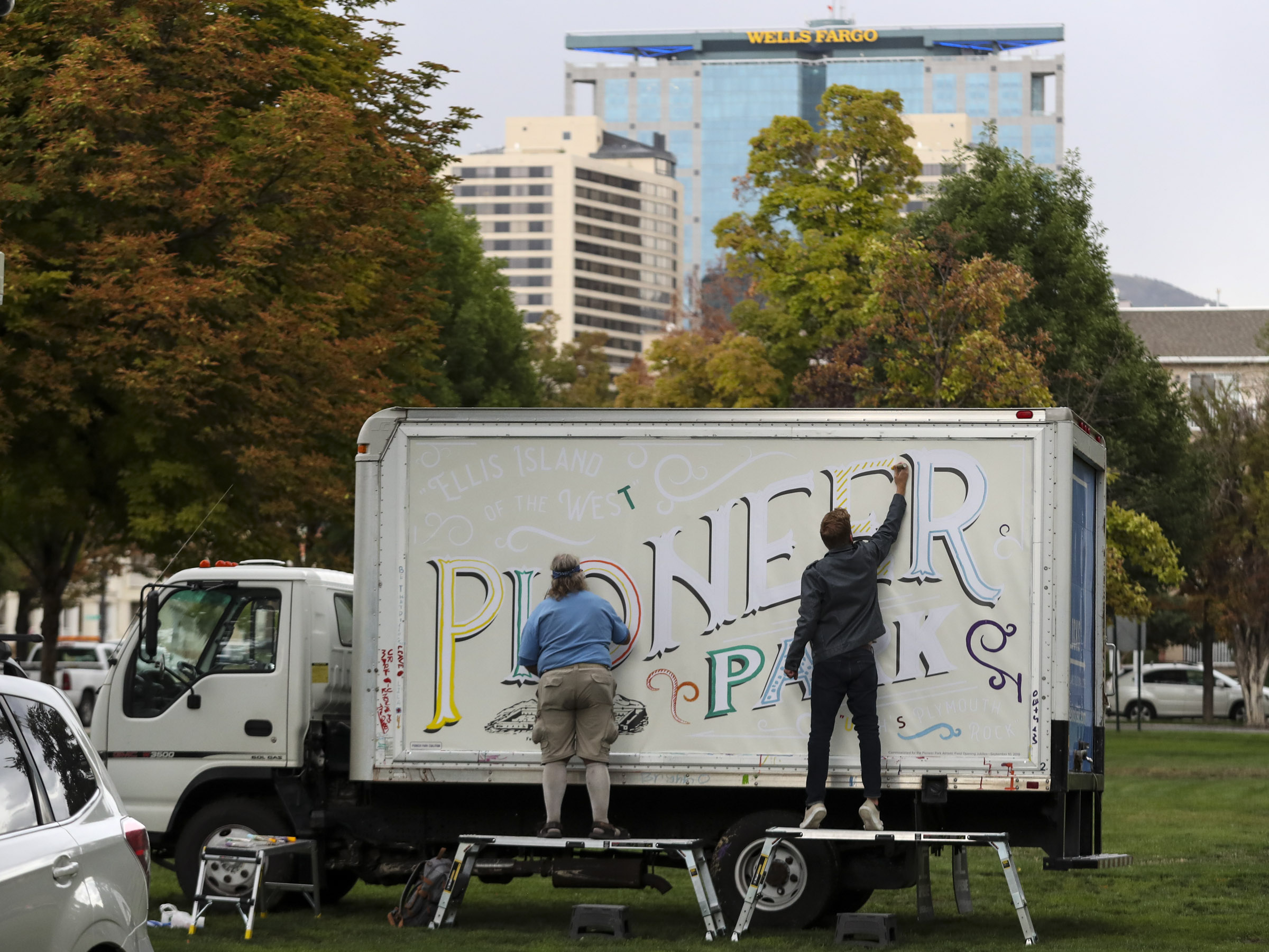Artists paint on a community art truck at Pioneer Park in Salt Lake City on Sept. 10, 2019. City officials announced they are seeking public input on ideas for the next phase of improvements for the downtown park. 