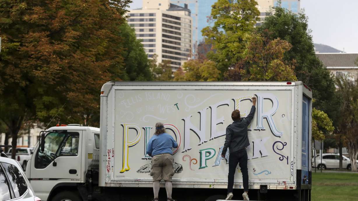 Artists paint on a community art truck at Pioneer Park in Salt Lake City on Sept. 10, 2019. City officials announced they are seeking public input on ideas for the next phase of improvements for the downtown park.