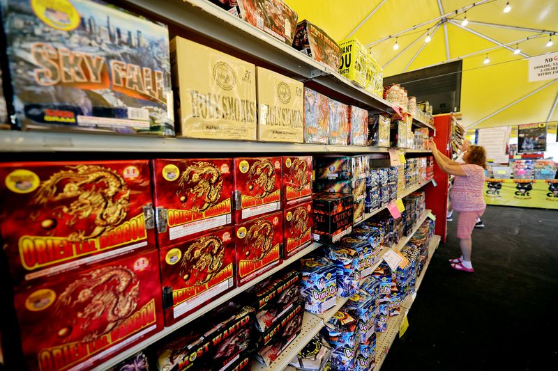 Worker Zelda Jensen adjusts products at Mad Matt’s
Fireworks on the corner of 9000 South and State Street in Sandy on
Monday, June 28, 2021.