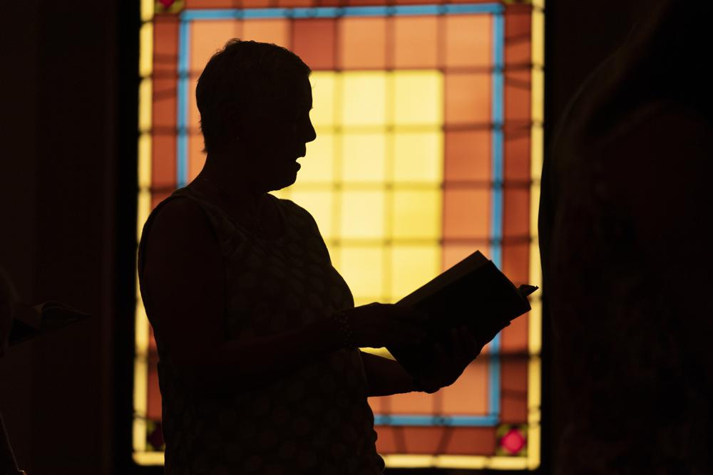 A member of Waldoboro United Methodist Church sings a hymn during a service, Sunday, June 20, 2021, in Waldoboro, Maine. The drop in attendance at the church, in part due to COVID-19, forced its closure.