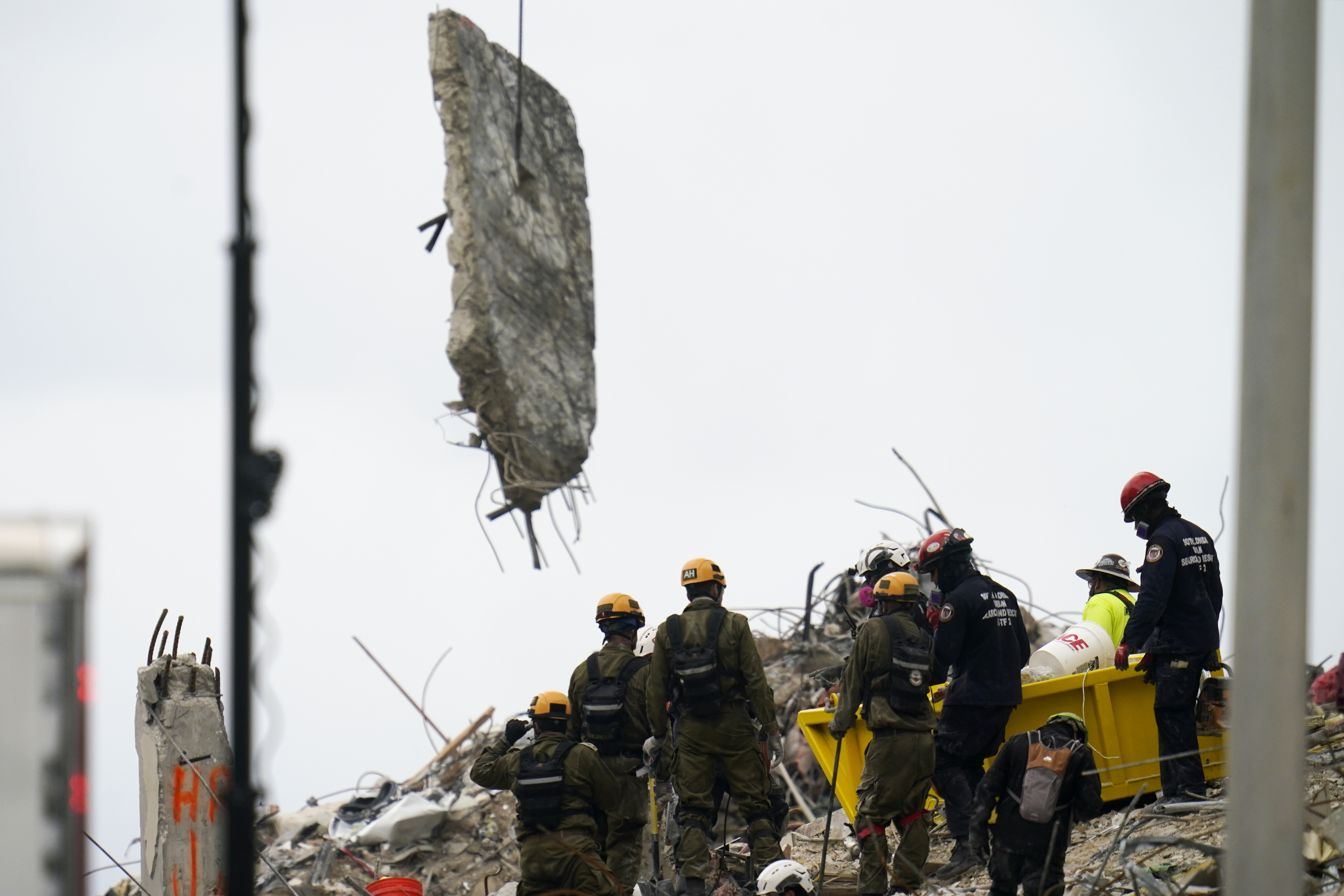 Crews work in the rubble of Champlain Towers South residential condo, Tuesday, June 29, 2021, in Surfside, Fla. The rescuers are searching urgently to find people buried beneath the fallen 12-story wing of the Champlain Towers condo building.