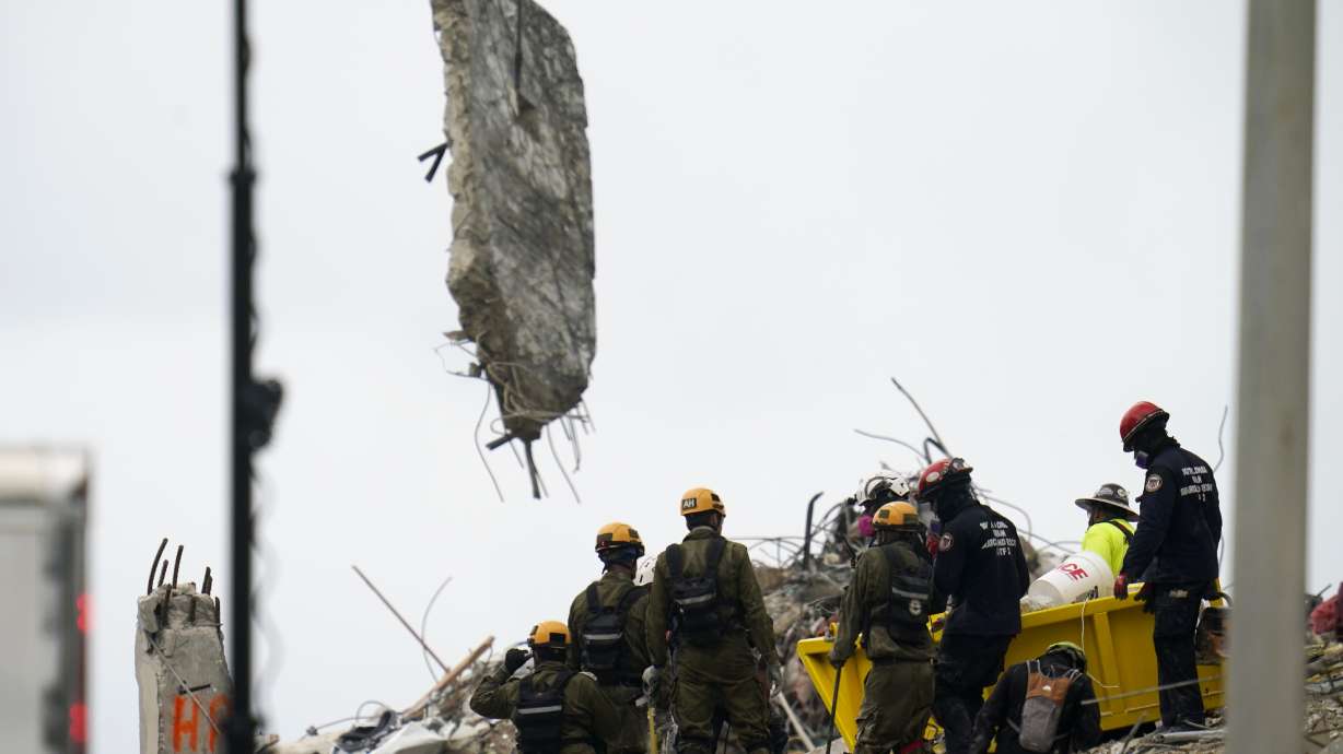Crews work in the rubble of Champlain Towers South residential condo, Tuesday, June 29, 2021, in Surfside, Fla. The rescuers are searching urgently to find people buried beneath the fallen 12-story wing of the Champlain Towers condo building.
