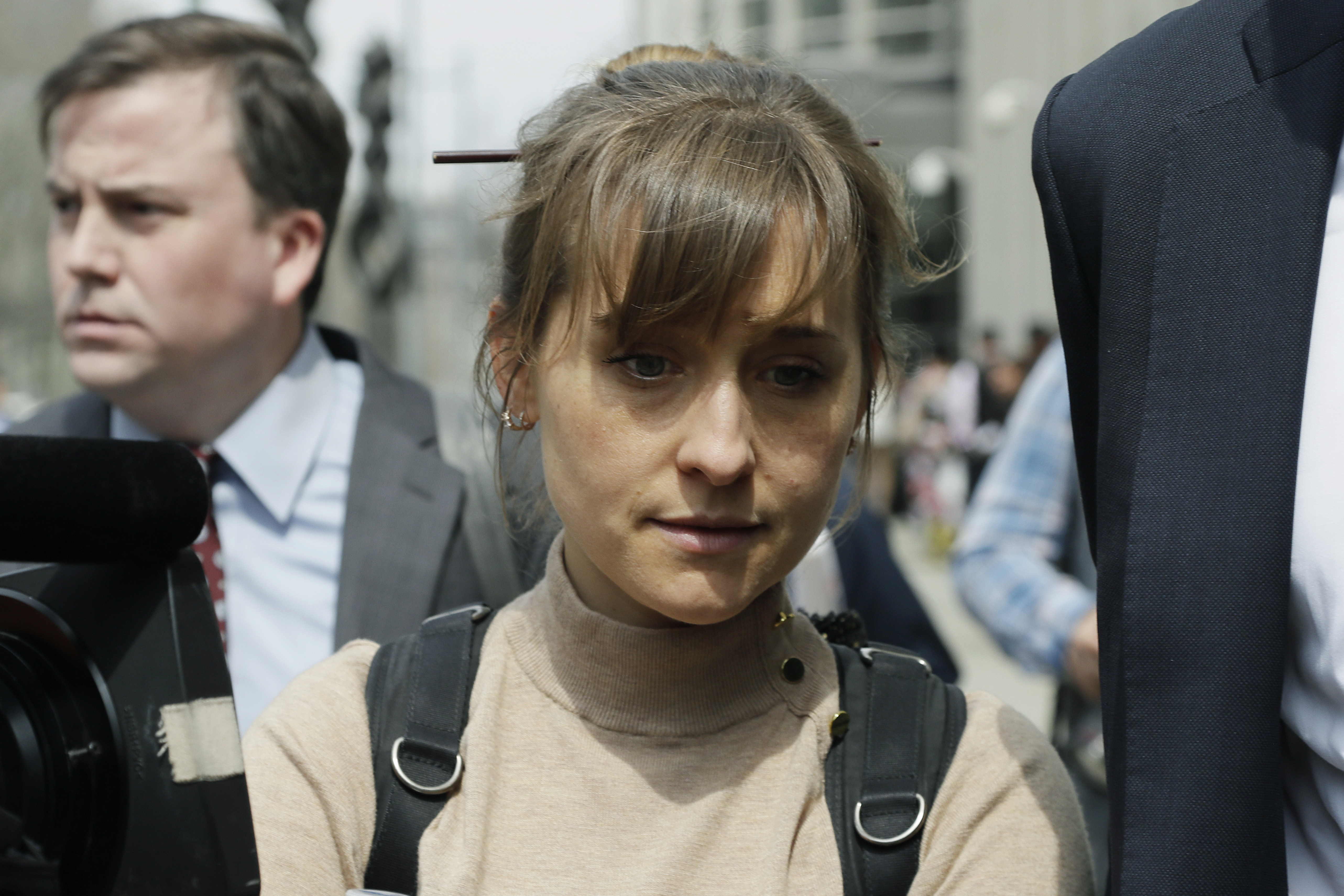In this Monday, April 8, 2019 photo, actress Allison Mack leaves Brooklyn federal court in New York. Mack, who played a key role in a scandal-ridden, cult-like upstate New York group, is facing sentencing Wednesday, June 30, 2021, after pleading guilty to charges she manipulated women into becoming sex slaves for the group’s spiritual leader. 