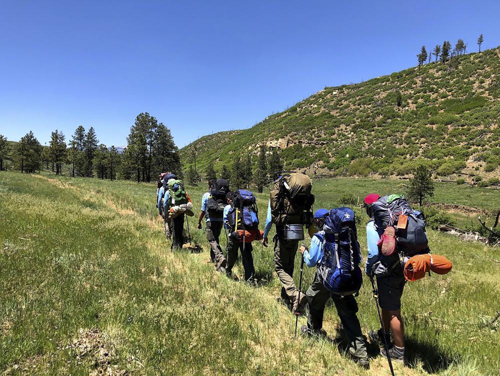 In this June 10, 2021, photo provided by Barry Bedlan, members of Troop 298 of Frisco, Texas, are among the first to embark a 12-day trek across the Philmont Scout Ranch, outside Cimarron, N.M. Boy Scout and Girl Scouts’ leadership say they have seen an unprecedented one-year drop in membership.