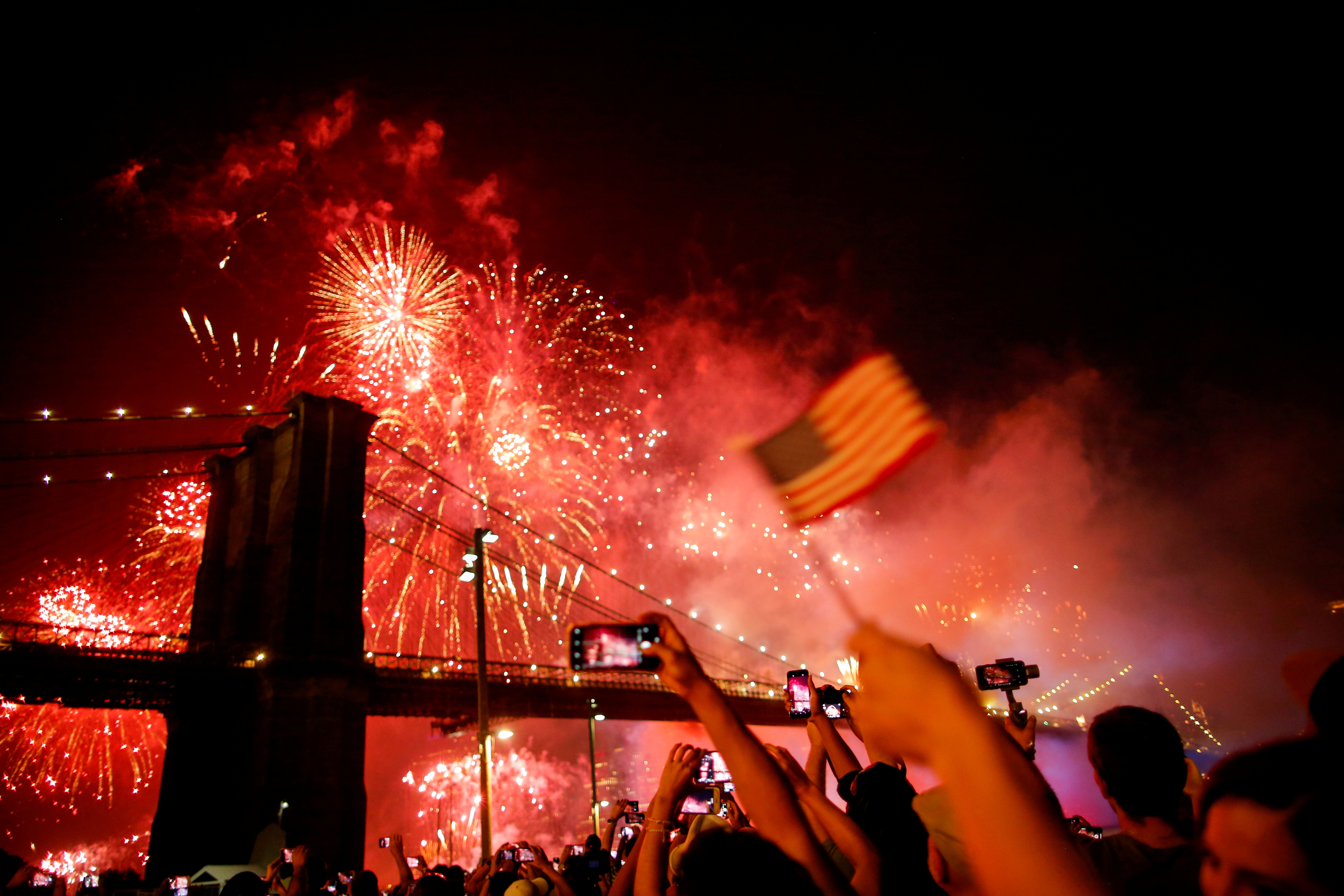 People watch the Macy's 4th of July Firework Show over the Brooklyn Bridge in New York, U.S., July 4, 2019.