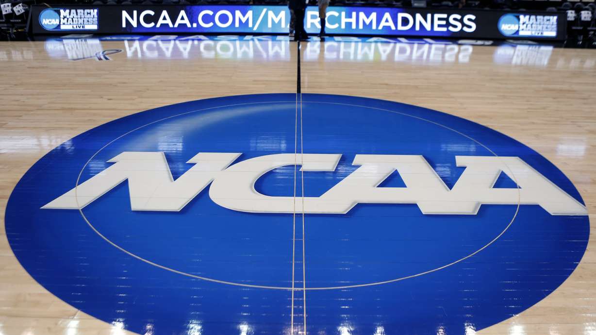 FILE - In this March 18, 2015, file photo, the NCAA logo is displayed at center court as work continues at The Consol Energy Center in Pittsburgh, for the NCAA college basketball tournament.