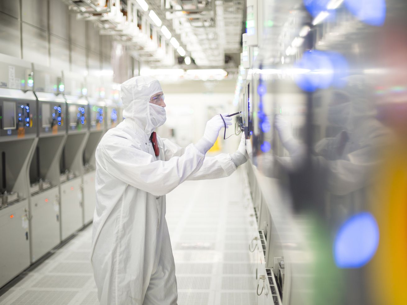 A worker at the Micron Technology semiconductor fabrication plant in Lehi. On Wednesday, Texas Instruments announced plans to buy the facility for $900 million.