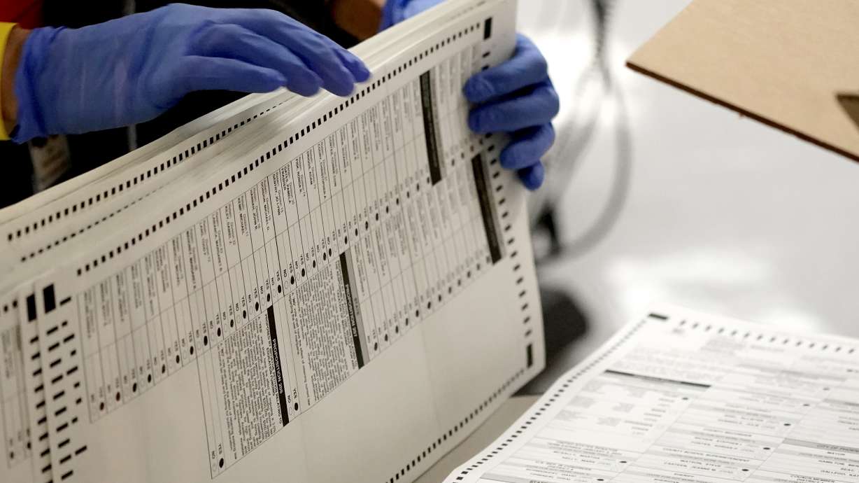In this Nov. 4, 2020, Maricopa County elections officials count ballots at the Maricopa County Recorder's Office in Phoenix. The Supreme Court on Thursday upheld voting restrictions in Arizona in a decision that could make it harder to challenge other voting measures put in place by Republican lawmakers following last year's elections.