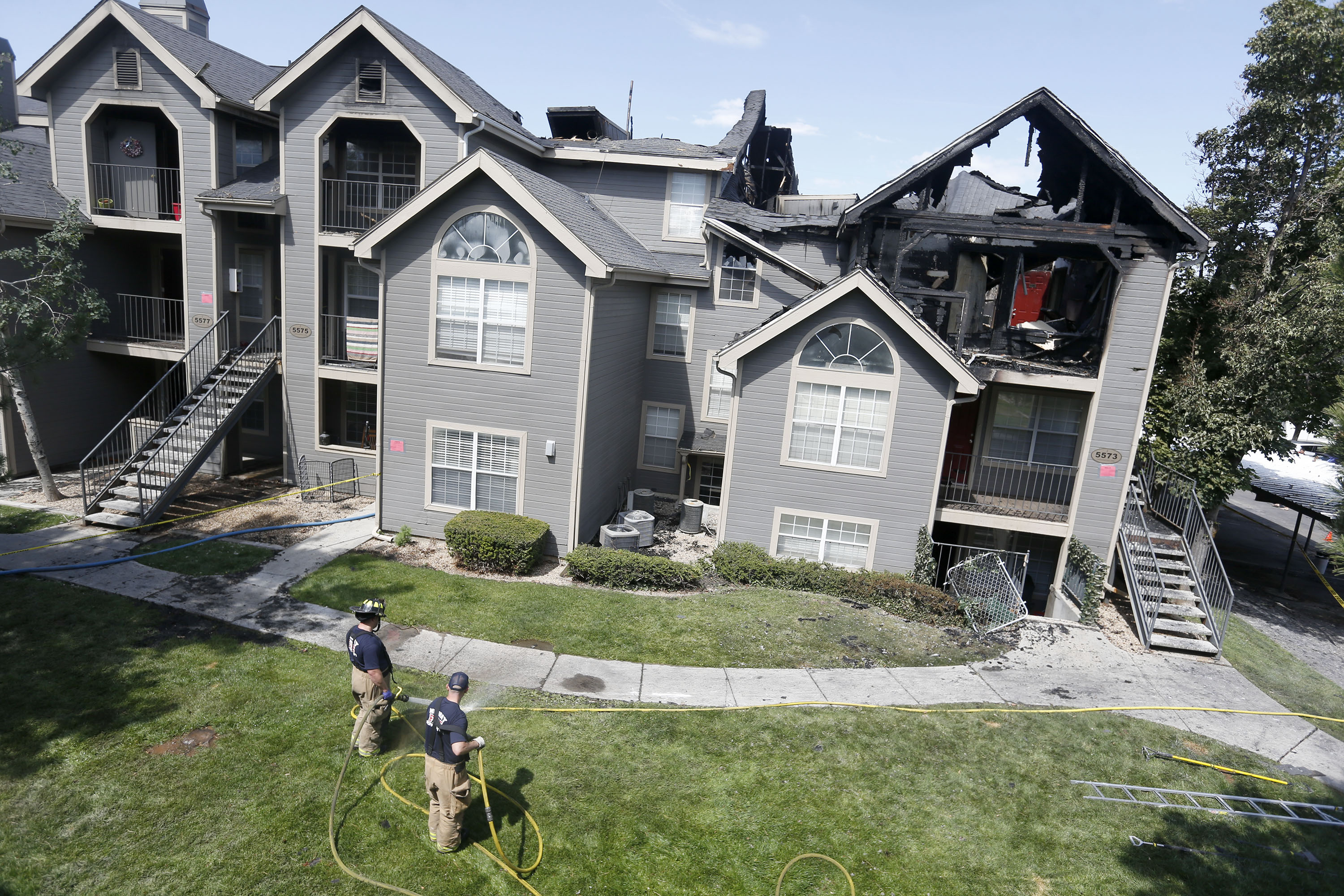 Murray firefighters clean up following a fire at the Stillwater Apartments near 5500 South and Vine Street in Murray on Thursday, July 1, 2021. Dozens of people were forced from their homes when fire broke out at the apartment complex early Thursday morning. Police have arrested a suspected arsonist, Forrest Xavier Wilkinson, who is believed to have set the fire.