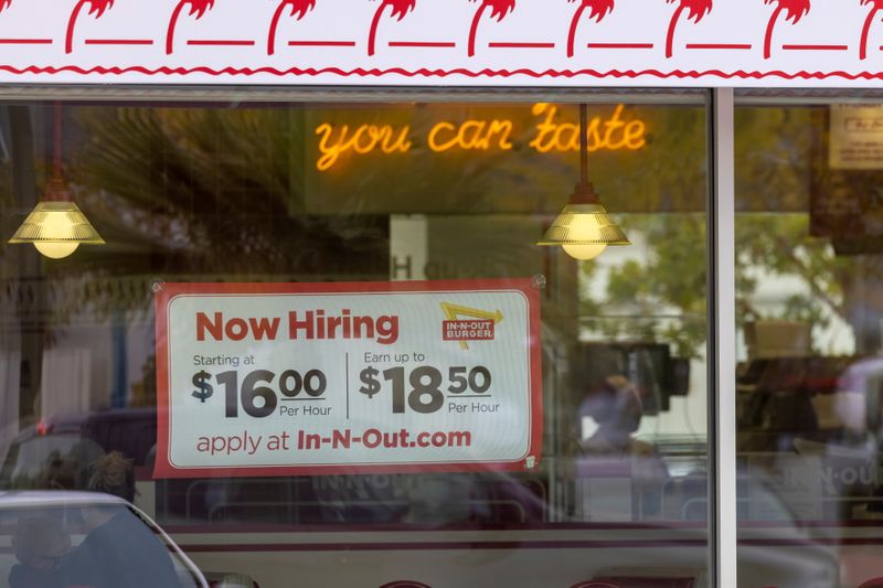An In-N-Out Burger advertises for workers at their restaurants location in Encinitas, California, May 10, 2021. U.S. job growth accelerated in June.