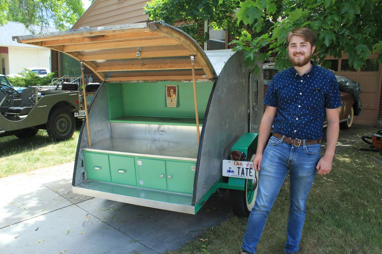 Tate Christensen poses with his first automotive project, a 1939 teardrop camp trailer.