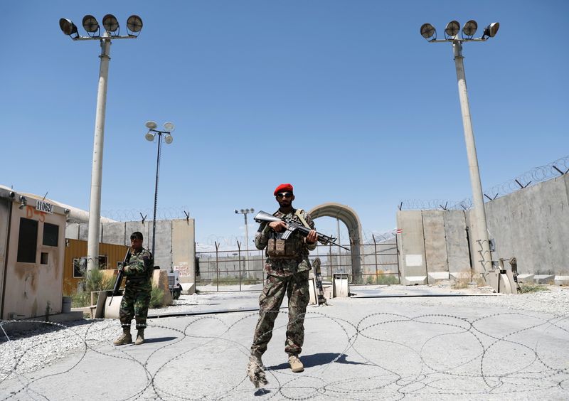 Afghan soldiers stand guard at the gate of Bagram U.S. air base, on the day the last of American troops vacated it, Parwan province, Afghanistan July 2, 2021.