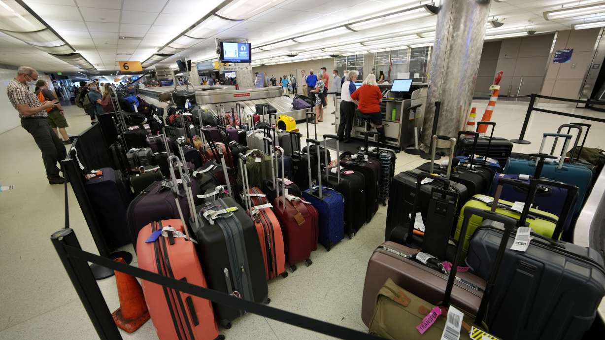 Baggage stacks up from delayed travelers in the baggage claim area in Denver International Airport Wednesday, June 16, 2021, in Denver. The Biden administration is planning to require that airlines refund fees on checked baggage if the bags get seriously delayed.