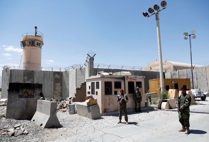 Afghan soldiers stand guard at the gate of Bagram U.S. air base, on the day the last of American troops vacated it, Parwan province, Afghanistan July 2, 2021.