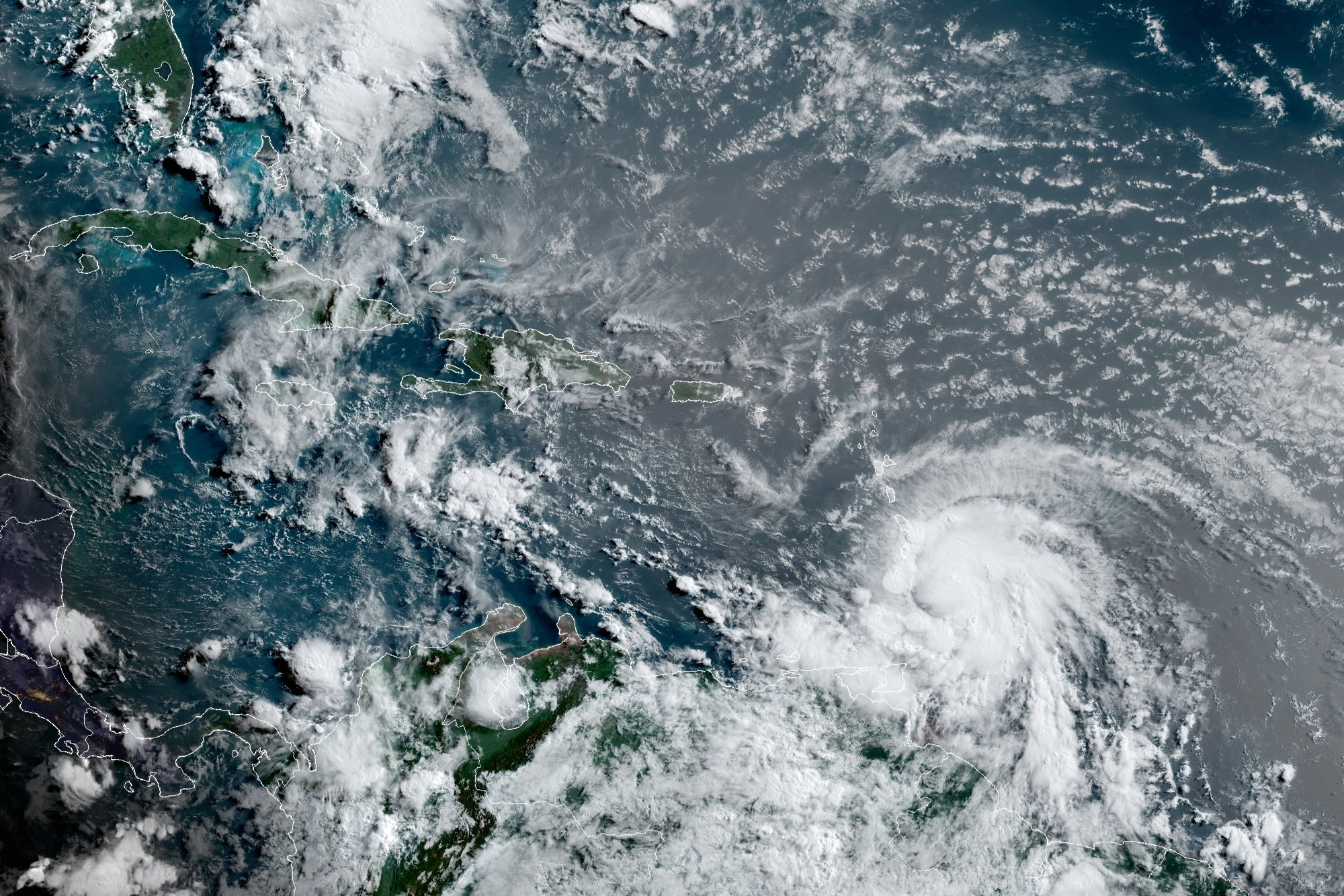 This satellite image provided by the National Oceanic and Atmospheric Administration shows Hurricane Elsa moving through the Caribbean, over Barbados, Tuesday, July 2, 2021, at 12:00 Z (8am a.m. ET). Elsa was expected to pass near the southern coast of Hispaniola on Saturday and to move near Jamaica and portions of eastern Cuba on Sunday. 