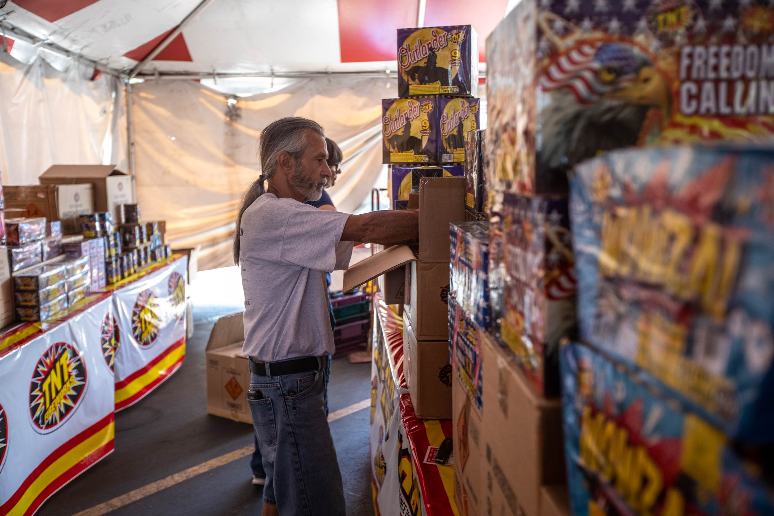 Wayne Valadez sets up fireworks in a tent in the Lucky parking lot a 729 N. Redwood Road in Salt Lake City on Monday June 28, 2021. Fireworks can be launched in certain locations and times on from July 2 to July 5 and July 22 to July 25.