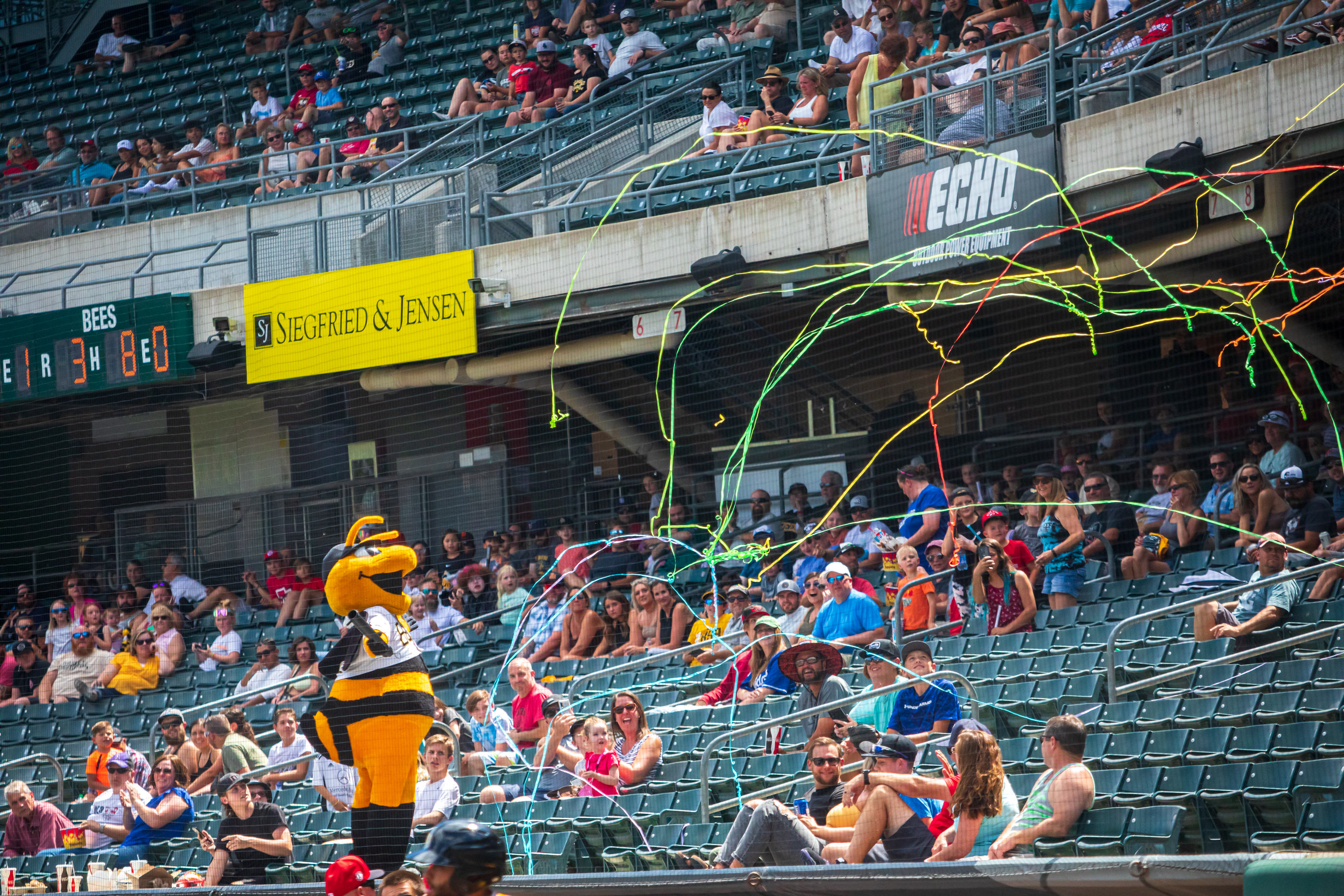 Bees mascot Bumble launches streamers into the seats at Smith's Ballpark during a Salt Lake Bees game on Sunday, June 27, 2021. The Bees have played at Smith's Ballpark since it opened in 1994.