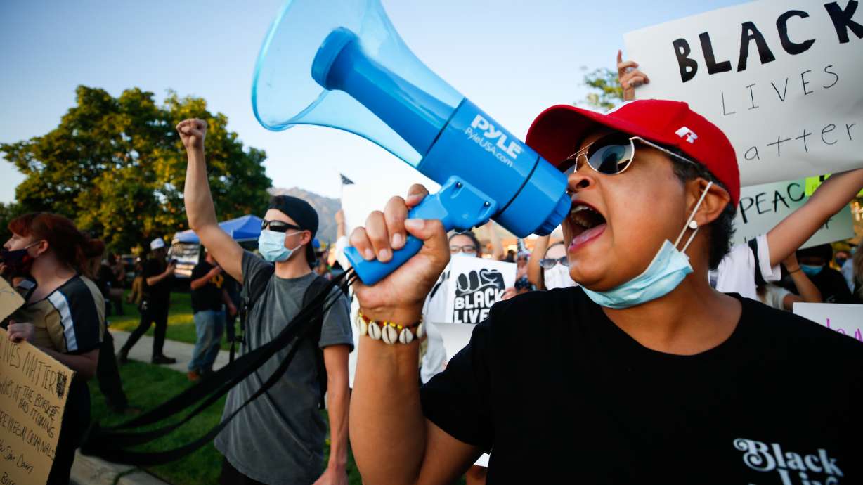 Lex Scott, founder of the Utah chapter of Black Lives Matter, chants as protesters and counterprotesters clash outside of the Cottonwood Heights Police Department in Cottonwood Heights on Aug. 3, 2020. Scott has stepped down as president of BLM Utah and the Utah Black History Museum.