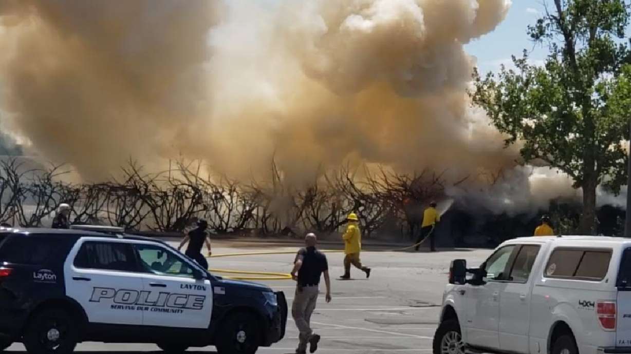 Firefighters respond to a grass fire near Layton Hills Mall on Friday, July 2, 2021. A woman was arrested on suspicion of arson in connection with the fire, according to Layton Fire Department.