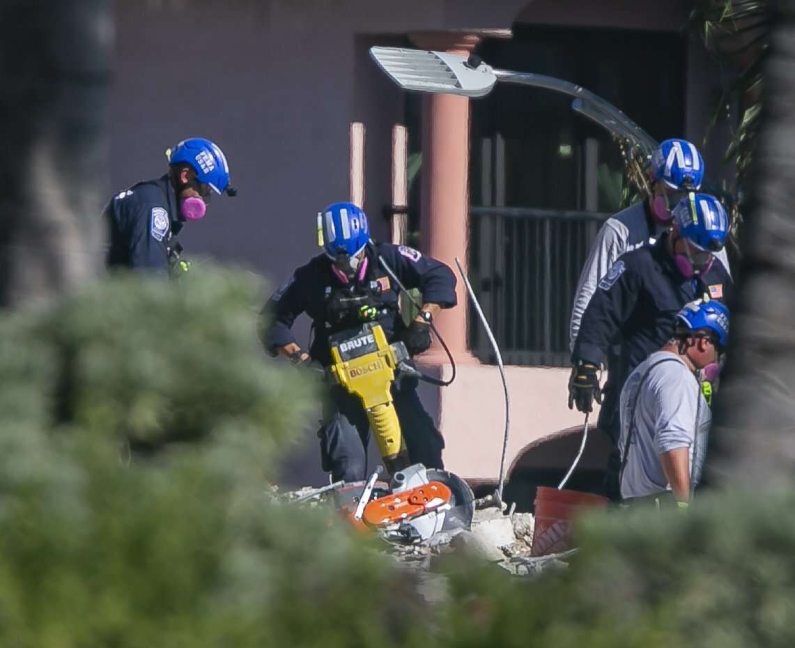 Rescue teams use jack hammers to chip through debris and rubble as they continue to look for survivors at the partially collapsed Champlain Towers South Condo building in Surfside, Fla., on Saturday, July 3, 2021.