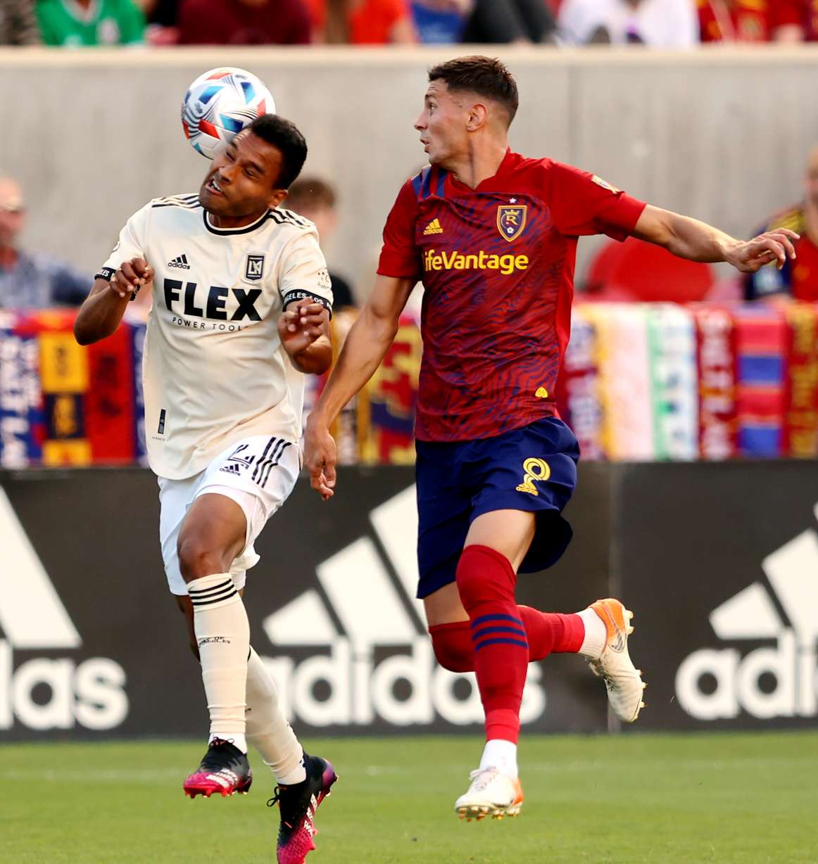 Los Angeles FC defender Eddie Segura (4) heads the ball away from Real Salt Lake midfielder Damir Kreilach (8) as RSL and LAFC play at Rio Tinto Stadium in Sandy on Saturday, July 3, 2021.