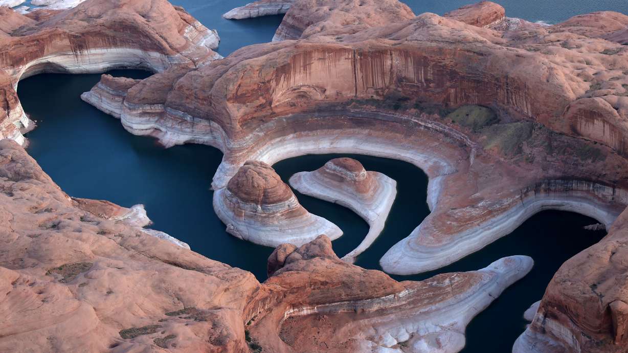 The tall bleached "bathtub ring" is visible on the rocky banks of Lake Powell at Reflection Canyon on June 24, in Lake Powell, Utah.