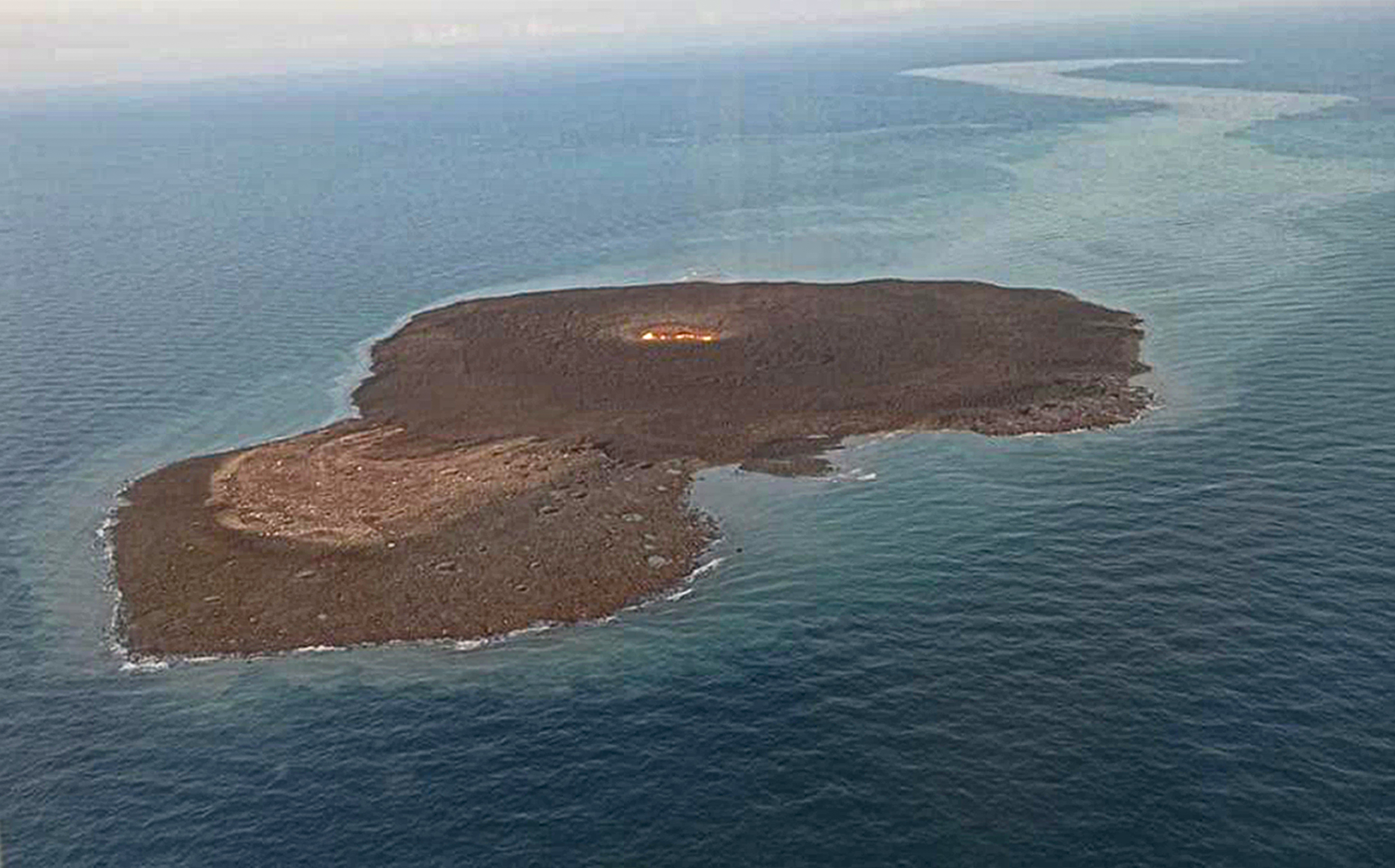 This photo released by Azerbaijani Ministry of Emergency Situations on Monday July 5, 2021 shows an aerial view of the aftermath of a strong explosion in the Caspian Sea area, about 10 kilometers (6 miles) from the Umid gas field, which is 75 kilometers (45 miles) off the coast of the capital, Baku. A strong explosion has shaken the Caspian Sea area where Azerbaijan has extensive offshore oil and gas fields and a column of fire rose late Sunday, but the state oil company says none of its platforms were damaged. The cause of the blast is not immediately determined, but state oil company SOCAR says preliminary information indicates it was a mud volcano. 