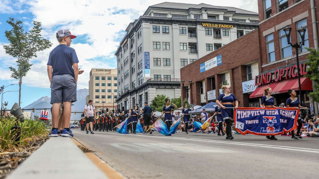 A child watches from the median as the Timpview High School Marching Band performs during the Grand Parade in Provo on Monday, July 5, 2021.