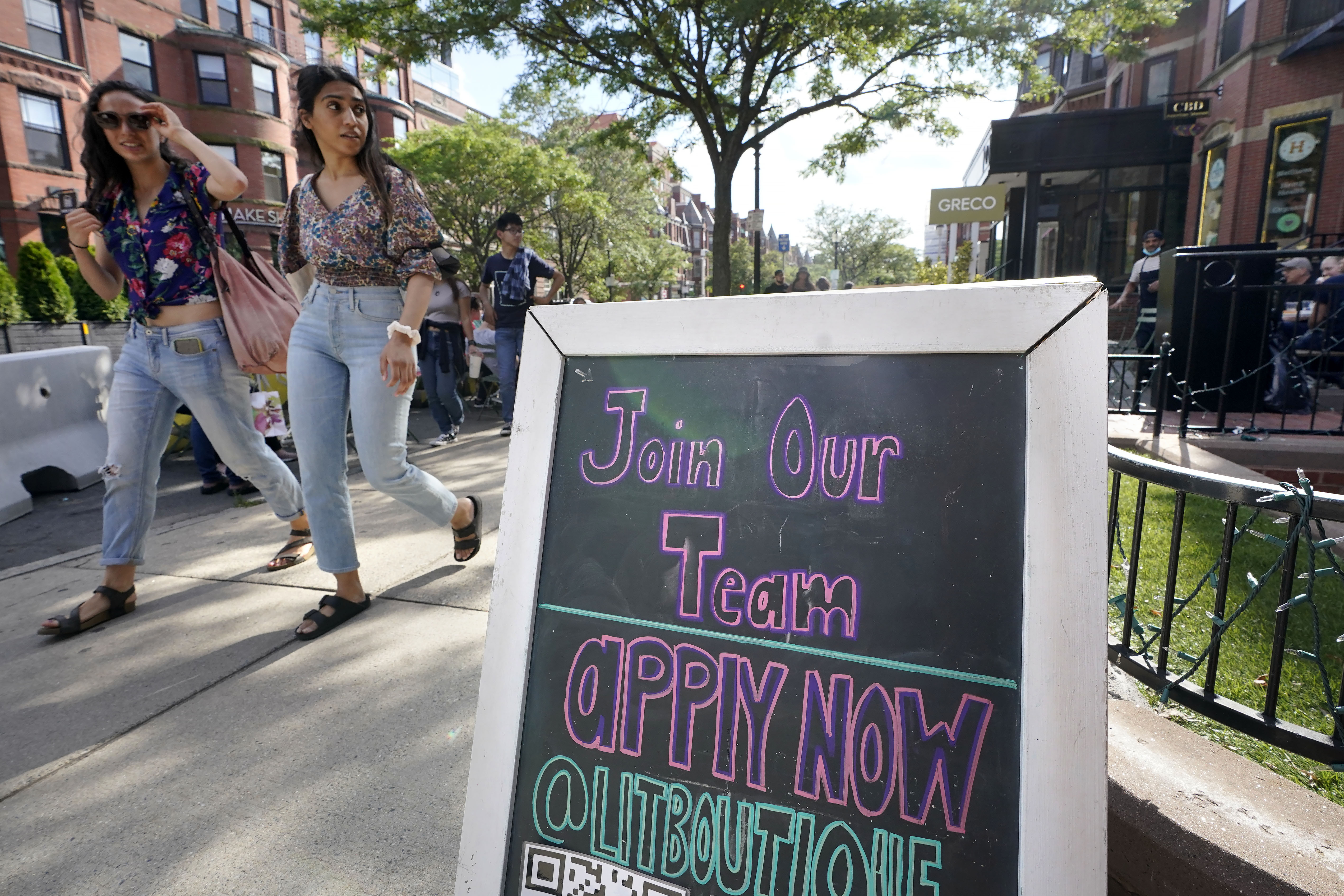 Pedestrians walk past a sign inviting people to apply for employment at a shop in Boston on Monday, July 5, 2021. As the U.S. economy bounds back with unexpected speed from the pandemic recession and customer demand intensifies, high school-age kids are filling jobs that older workers can’t — or won’t. 
