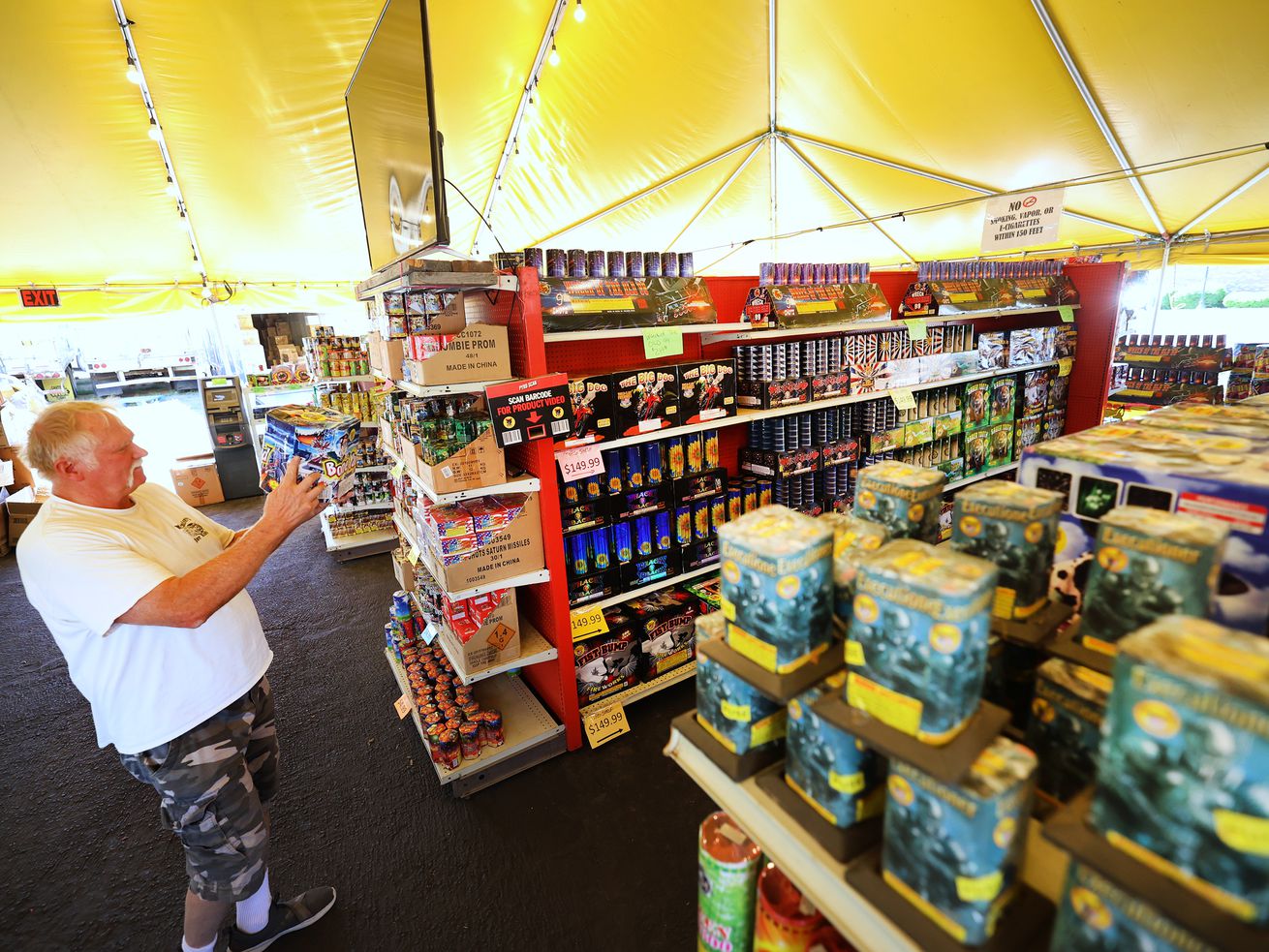 Worker George Jensen uses a product scanner to see what different items will look like at Mad Matt’s Fireworks on the corner of 9000 South and State Street in Sandy on Monday, June 28, 2021.