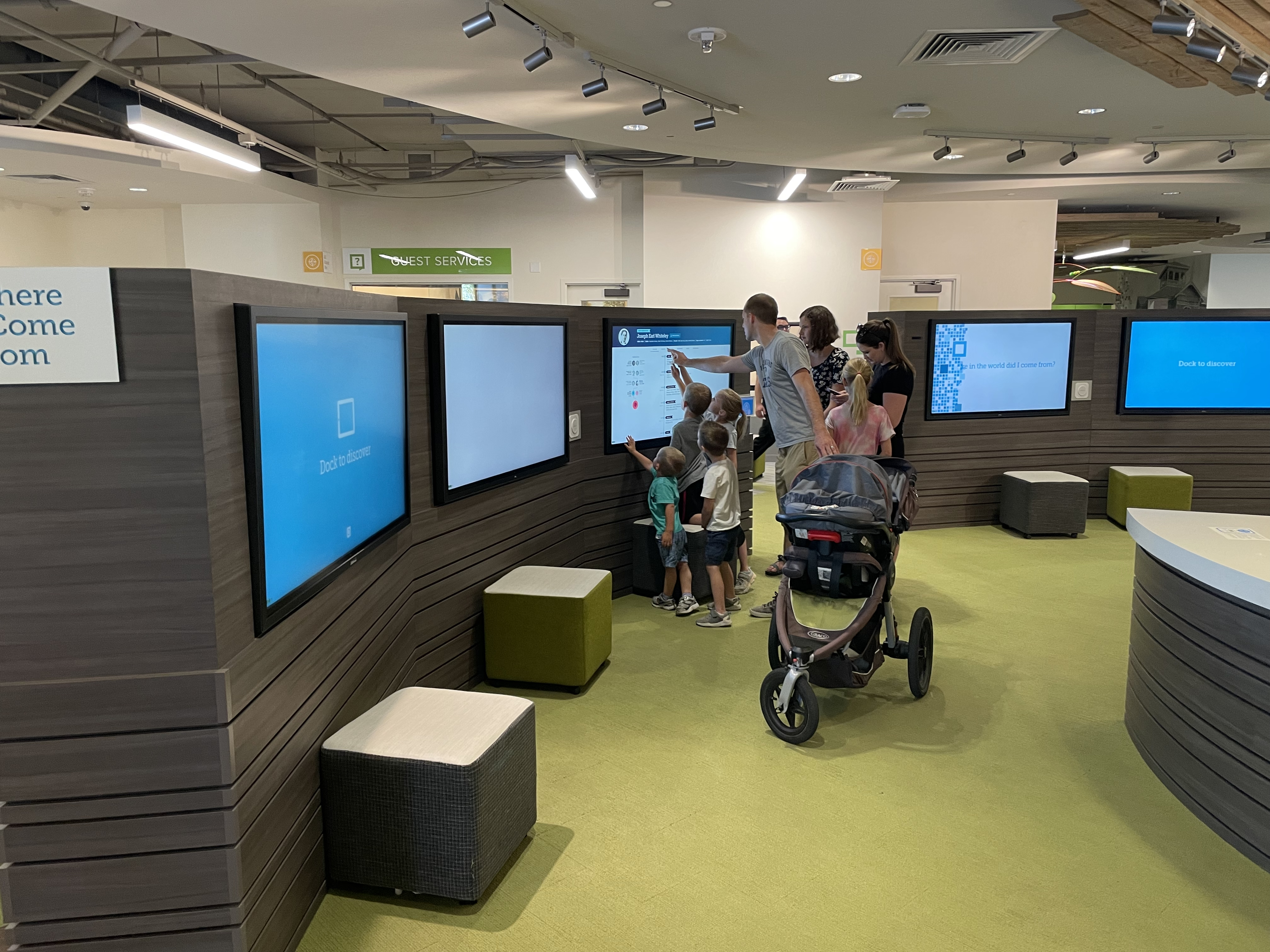 A family looks at an interactive feature at the FamilySearch Family History Library in Salt Lake City as it reopened on Tuesday, July 6, 2021.