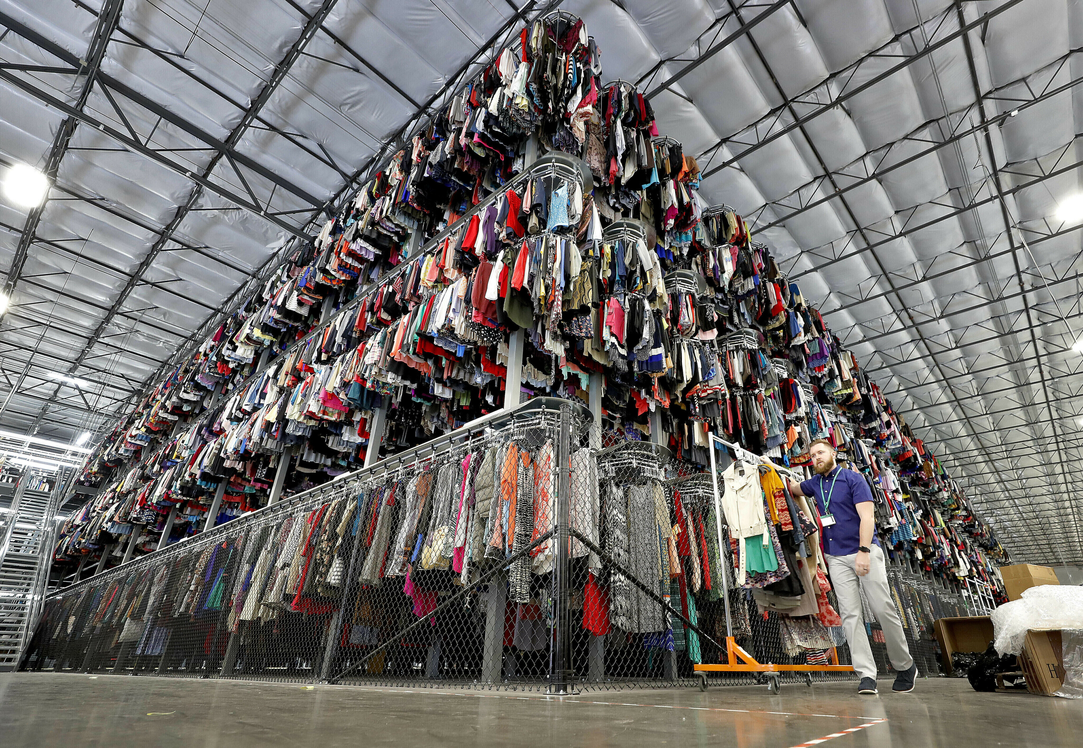 Thousands of garments are stored on a three-tiered conveyor system at the ThredUp sorting facility in Phoenix on March 12, 2019. A wardrobe purge is on for some and the primary beneficiaries are secondhand clothing marketplaces, and brick-and-mortar donation spots. 