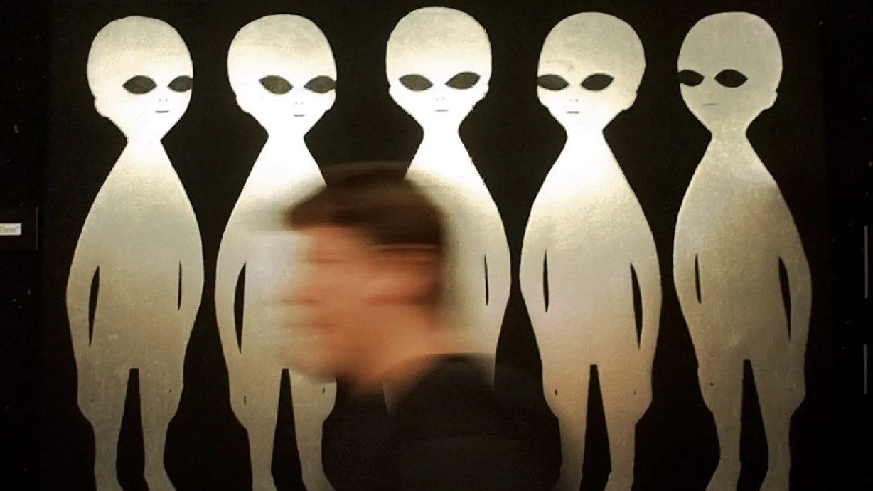 A patron passes a painting inside the International UFO Museum and Research Center in Roswell, N.M. in June 1997.