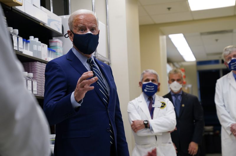 President Joe Biden speaks during a visit at the Viral
Pathogenesis Laboratory at the National Institutes of Health on
Thursday, Feb. 11, 2021, in Bethesda, Md. Dr. Anthony Fauci,
director of the National Institute of Allergy and Infectious
Diseases and NIH Director Francis Collins listen.