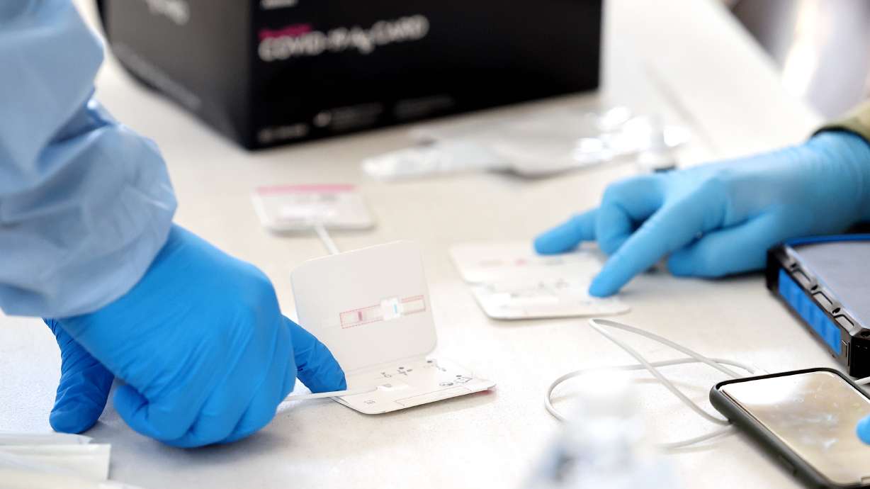Eric Kwiatkowski, with the Utah National Guard's Forward Support Company in St. George, and Pfc. Jacob Osborne, with the guard's 19th Special Forces in Bluffdale, process COVID-19 tests at the Utah State Fairpark in Salt Lake City on Tuesday, July 6, 2021. Utah is now sixth-worst in the United States for COVID-19 case rates, officials said Wednesday.