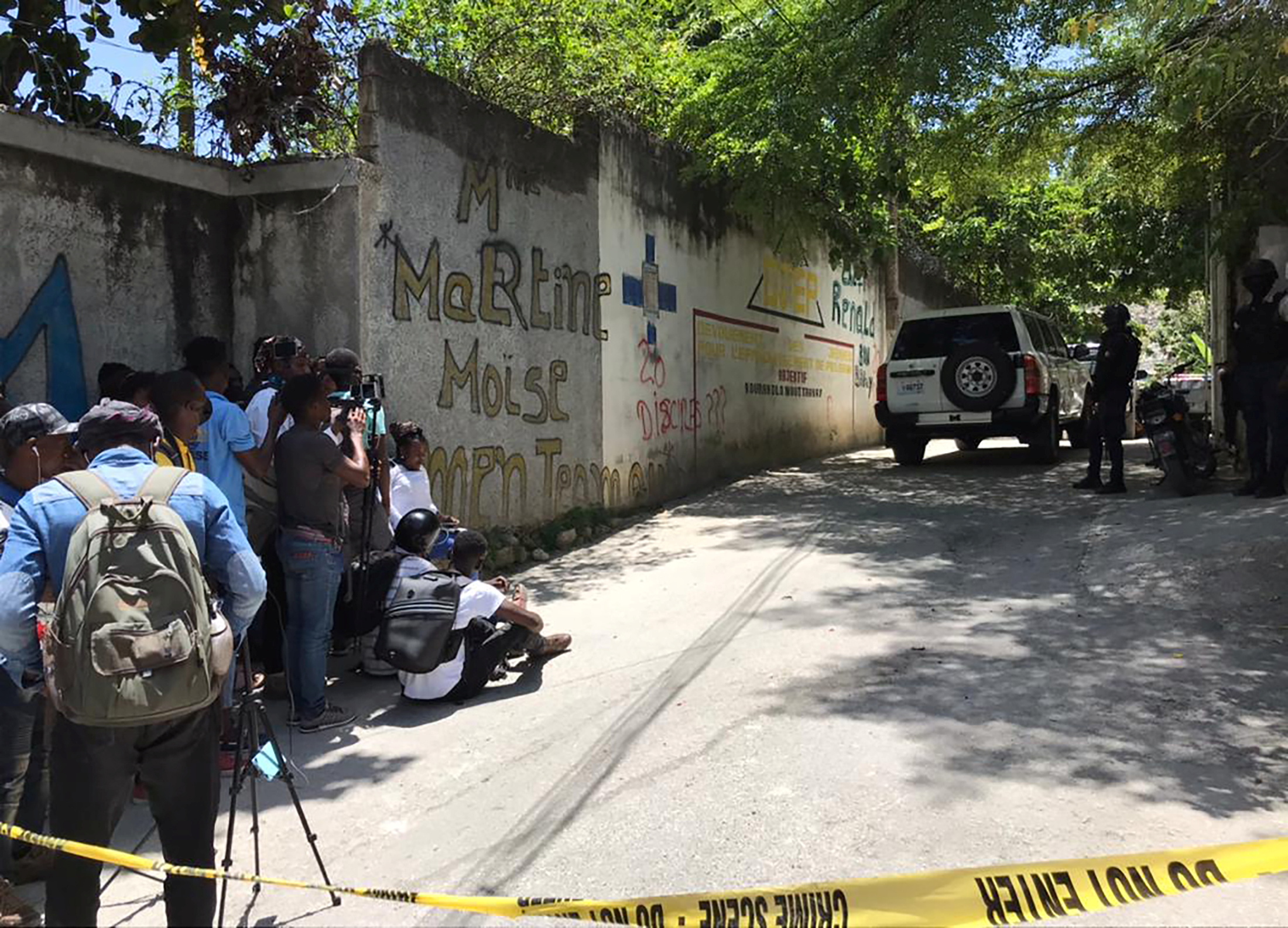 Journalists stand next to a yellow police cordon near the residence of Haiti's President Jovenel Moise after he was shot dead by unidentified attackers, in Port-au-Prince, Haiti July 7, 2021.