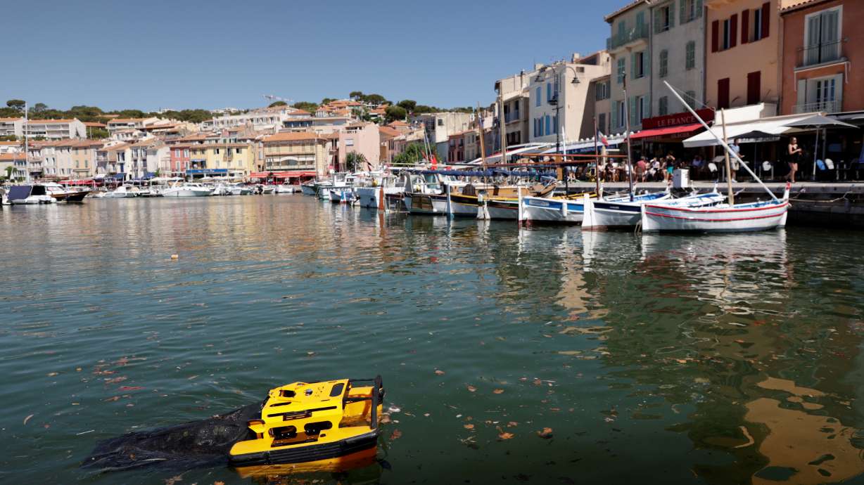 The Jellyfish, a little catamaran operated by remote control, which is capable of cleaning water by collecting rubbish on the water's surface is seen at work in the port of Cassis, southern France, July 5, 2021.