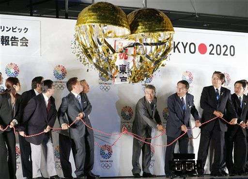 Tokyo Gov. Naoki Inose, front row third left, along
with Tokyo 2020 bid team members and others pull a rope to open a
decorated paper ball celebrating Tokyo’s successful bid to host the
2020 Summer Olympics and Paralympics during a special event at the
Tokyo Municipal Government main office in Tokyo Tuesday, Sept. 10,
2013.