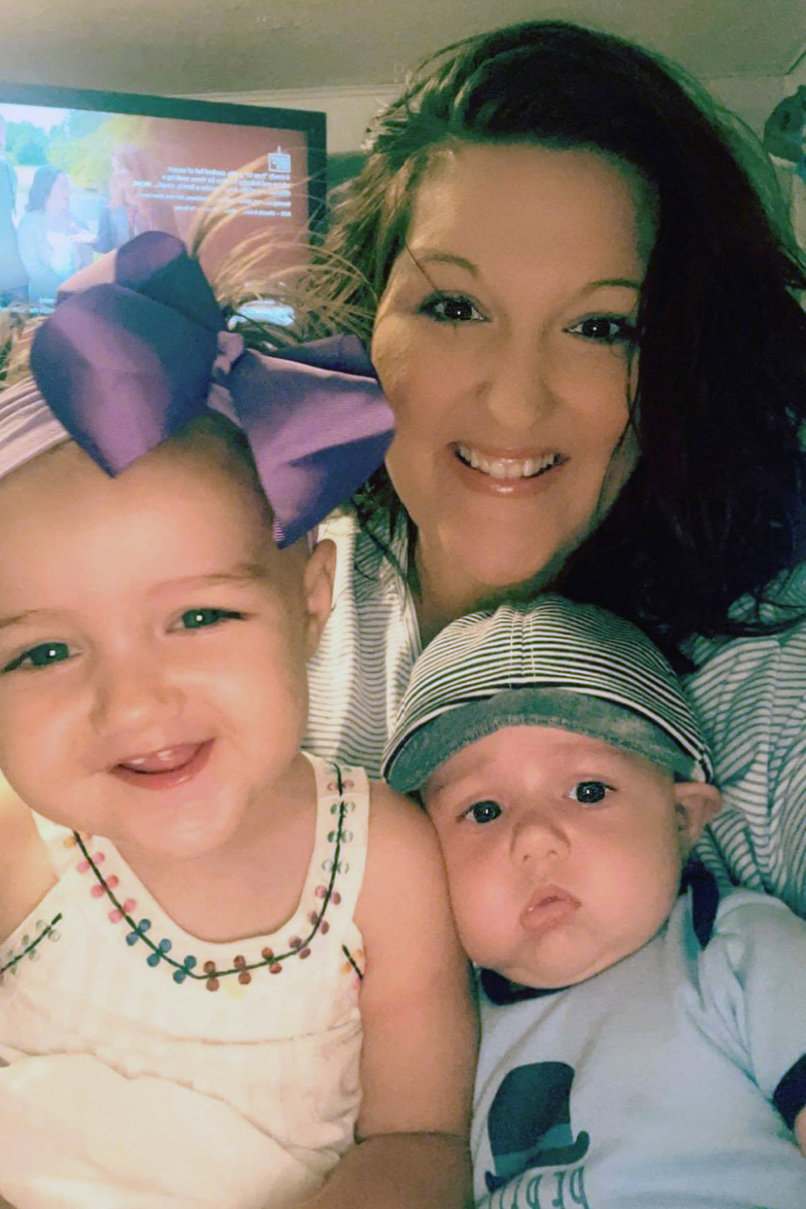 This June 2021 photo provided by LaRanda St. John shows her with her children, Lulabelle and Beau, at their home in Mattoon, Ill.