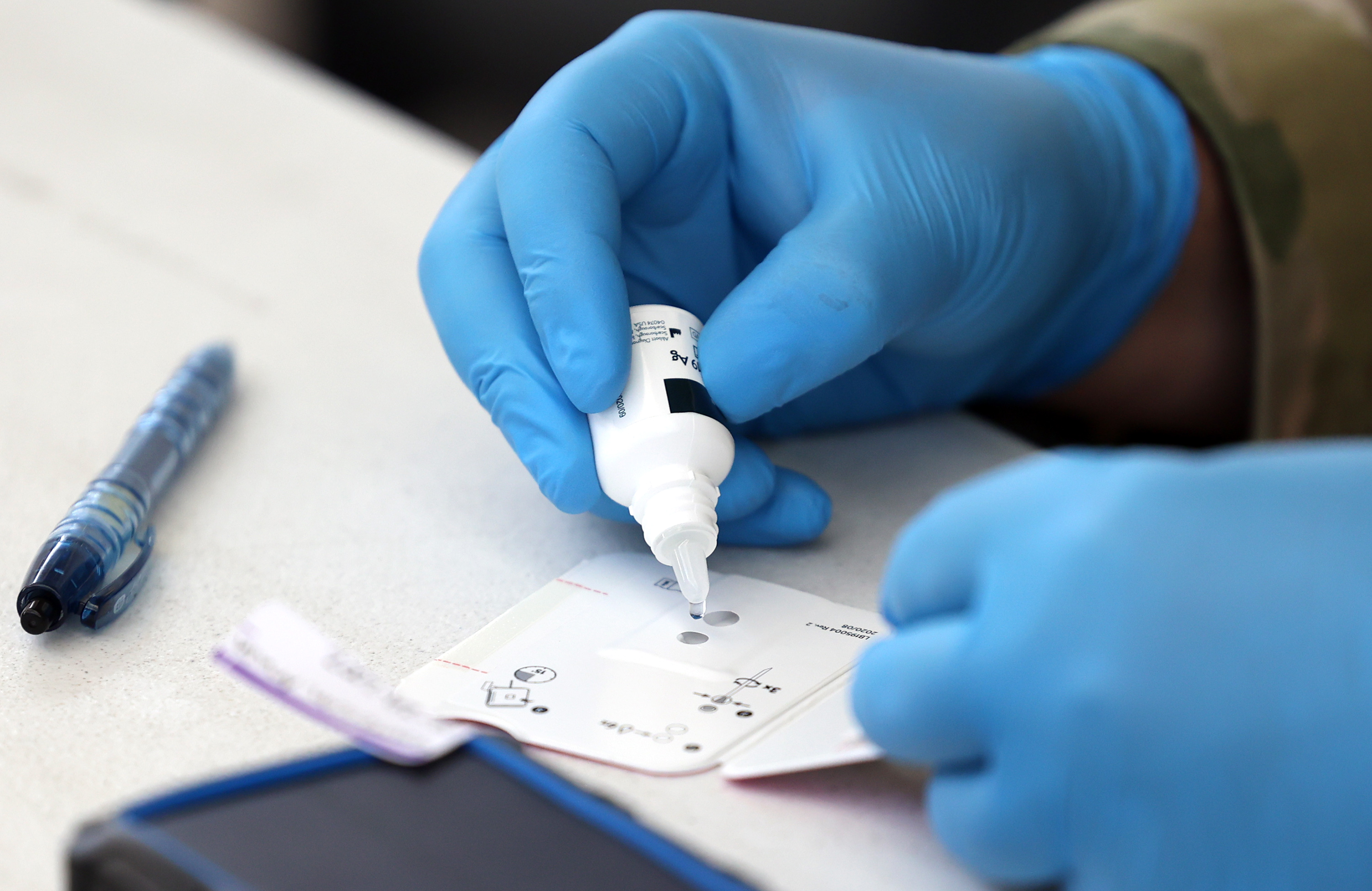 Utah National Guard Pfc. Jacob Osborne applies a reagent to a BinaxNOW COVID-19 Ag Card at a COVID-19 testing site at the Utah State Fairpark in Salt Lake City on July 6, 2021. Utah reported 559 new COVID-19 cases on Tuesday.