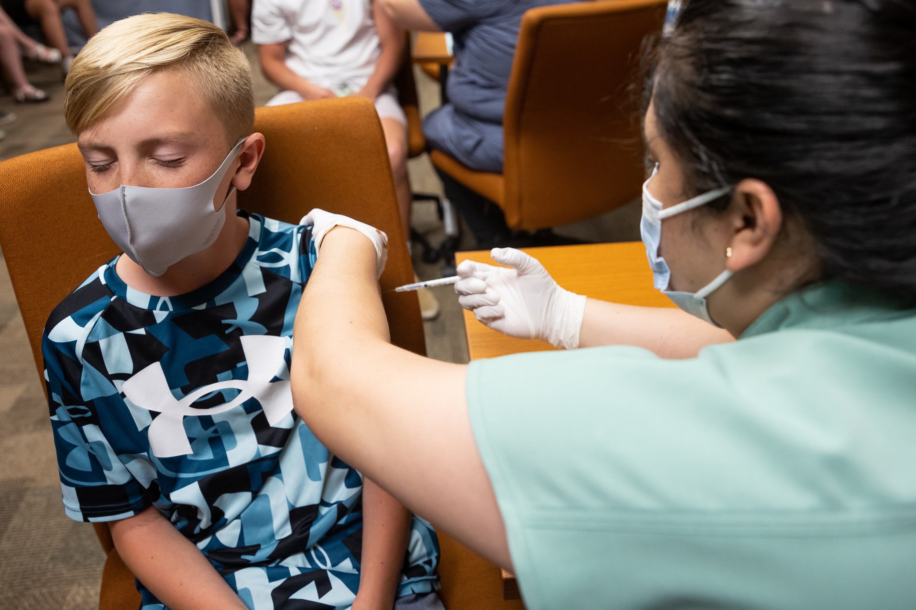 Jack Allen, 12, closes his eyes as he gets a shot of the Pfizer-BioNTech COVID-19 vaccine from nurse Estefania Cruz at the Central Davis Senior Activity Center in Kaysville on Tuesday, July 6, 2021.