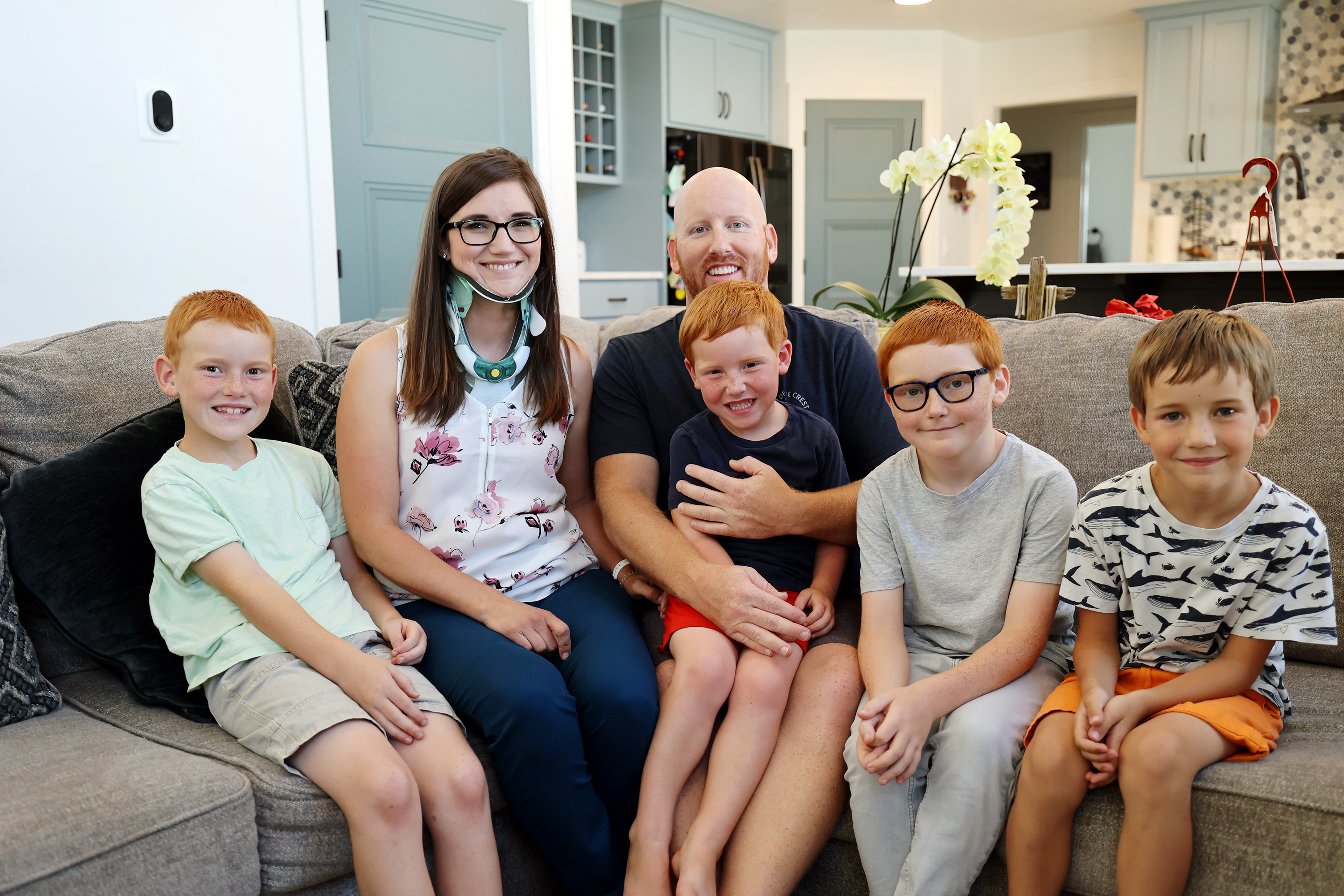 Brooke Andersen, second from left, poses for a photo with husband Tevor and sons Bridger, Graysen, Kamden and Pierce at their home in Provo on Wednesday, July 7, 2021. Brooke Andersen's spinal fusion surgery was delayed because of COVID-19 closures, but she finally made it to Spain during its brief opening window to have it. Now she can walk again, but she's still facing a lifetime of deterioration from her condition.
